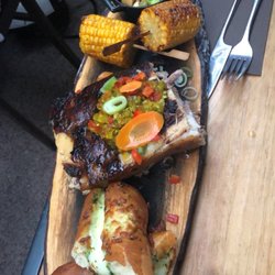 Le Couperet - Delicious barbecue pork (cochon) with garlic cheesy bread, corn on the cob, and loaded potatoes.