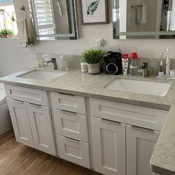 CAA Hawaii Cabinet - Downstairs bathroom cabinets, sinks, and countertop.
