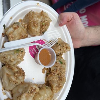 Smorgasburg - a person holding a plate of food - Food Court Near Me - New York, New York