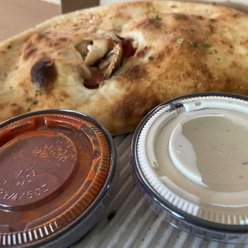 Dewey's Pizza - Crestview Hills - a piece of pizza and a container of sauce - Pizza Near Me - Crestview Hills, Kentucky Dewey's Pizza - Crestview Hills - a piece of pizza and a container of sauce - Pizza Near Me - Crestview Hills, Kentucky