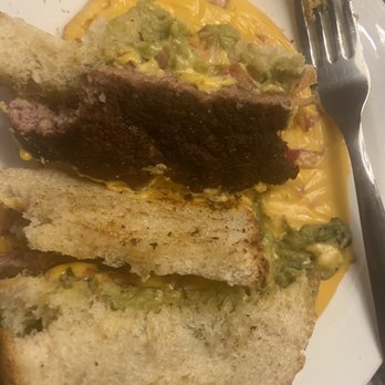 The Taproom - Here's the overcooked patty on untoasted bread. RIP the original Guacamole Queso Burger - Burgers Near Me - San Marcos, Texas
