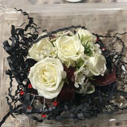 D' Agee & Co. Florist - The corsage. It's sitting on the black shredded paper, but that's not part of it.