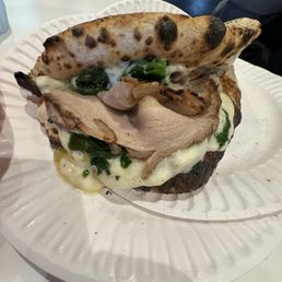 Panuozzo with Porchetta, broccoli rabe, and provolone. Panuozzo with Porchetta, broccoli rabe, and provolone.