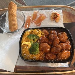 Combo plate with egg roll, egg fried rice, and General Tso's chicken and broccoli.