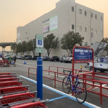 Lowe's Home Improvement - 2 cyclists in rear of photo who also had to lock bikes to the cart bay - Hardware Stores Near Me - Brooklyn, New York