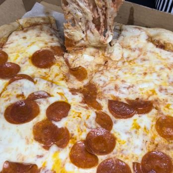Lenny's New York Pizza - a slice being taken out of a pizza box - Pizza Near Me - Ormond Beach, Florida