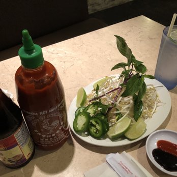 Pho Us - a plate of salad and two bottles of sauce - Vietnamese Near Me - Houston, Texas Pho Us - a plate of salad and two bottles of sauce - Vietnamese Near Me - Houston, Texas