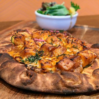 Curry Up Now - Naughty Naan w/ paneer. Flatbread of flour kulcha naan, mozzarella, caramelized onions, shaved jalapeno, local seasonal greens. $11. - Indian Near Me - Decatur, Georgia Curry Up Now - Naughty Naan w/ paneer. Flatbread of flour kulcha naan, mozzarella, caramelized onions, shaved jalapeno, local seasonal greens. $11. - Indian Near Me - Decatur, Georgia