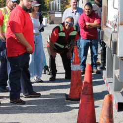 New England Tractor Trailer Training School - CDL Instructors helping with straight-back practice in the CDL training field.