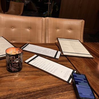 Old Hickory Steakhouse - a table with menus and a cell phone - Steakhouses Near Me - Grapevine, Texas