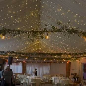 Illuminating Design - Indoor event space decorated with warm string lights across the ceiling, creating an inviting atmosphere for guests. - Lighting Fixtures & Equipment Near Me - Peachtree Corners, Georgia Illuminating Design - Indoor event space decorated with warm string lights across the ceiling, creating an inviting atmosphere for guests. - Lighting Fixtures & Equipment Near Me - Peachtree Corners, Georgia