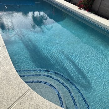 Puddle Jumper Pool Service, LLC - New pebble interior, waterline tile, and glass step tiles. - Pool Cleaners Near Me