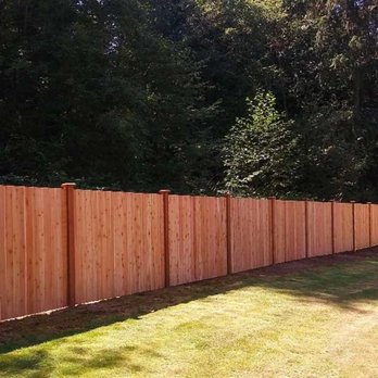 Arc Landscape - a wooden fence in a back yard - Landscaping Near Me