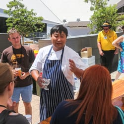The Blue Hive - Mapo chef, Chung Jae Mao explaining how to make up a giant bibimbap to feed a few hundred guests at The Blue Hive.