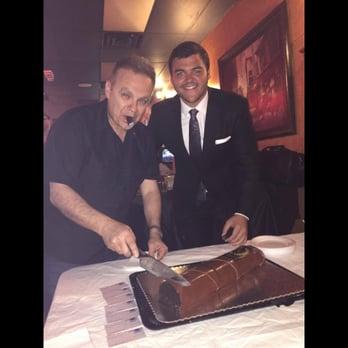 The Cigar Lounge - two men cutting a cake - Hookah Bars Near Me - Oviedo, Florida The Cigar Lounge - two men cutting a cake - Hookah Bars Near Me - Oviedo, Florida