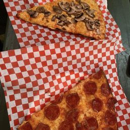 slice of cheese with mushrooms and a slice of pepperoni