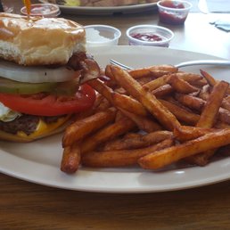 Cheese burger with bacon and cajun fries. Cheese burger with bacon and cajun fries.