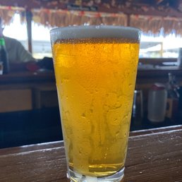 a glass of beer on a bar a glass of beer on a bar