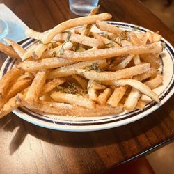 Artisanal Burger Company - Truffle Fries. On side Truffle oil and olive oil.