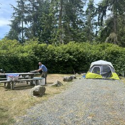 Campsite with one tent in (on gravel)