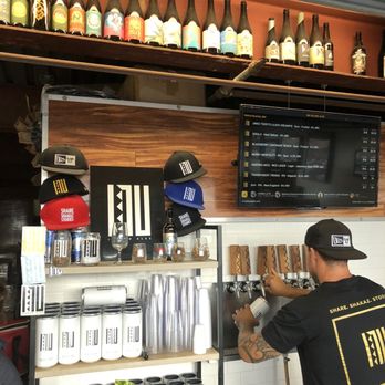 Inu Island Ales - Inside - beer tender doing his thing. Solid selection and cool merch - Breweries Near Me - Kaneohe, Hawaii Inu Island Ales - Inside - beer tender doing his thing. Solid selection and cool merch - Breweries Near Me - Kaneohe, Hawaii