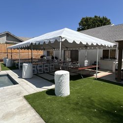 20'x40' tent with set up of 8' rectangular tables and white folding chairs