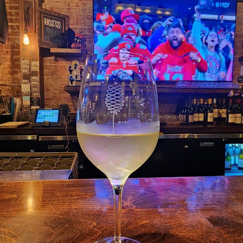 Enjoying a Chardonnay at the bar, watching the football game Enjoying a Chardonnay at the bar, watching the football game