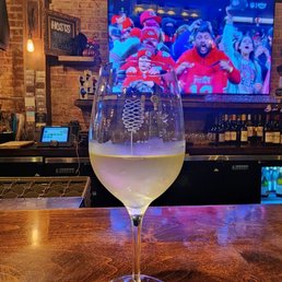 Enjoying a Chardonnay at the bar, watching the football game