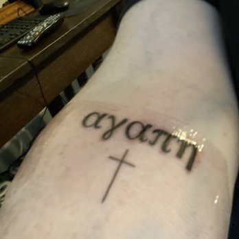 Singleton Tattoo - My tattoo says Agape in Greek lettering with a small cross below it. - Tattoo Near Me - Dallas, Texas