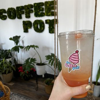 The Coffee Pot - Sunset Lotus drink in front of The Coffee Pot's indoor swing and signage. - Coffee & Tea Near Me - Freeburg, Illinois The Coffee Pot - Sunset Lotus drink in front of The Coffee Pot's indoor swing and signage. - Coffee & Tea Near Me - Freeburg, Illinois