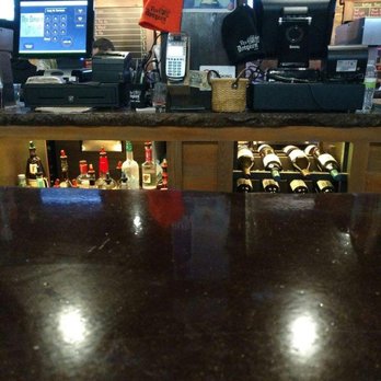 The Dungeon - a bar counter with bottles of alcohol - Pubs Near Me - Dubuque, Iowa
