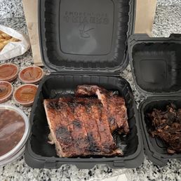 1/2 rack ribs, burnt ends( right) 2 orders of baked beans, fries and sauce. 1/2 rack ribs, burnt ends( right) 2 orders of baked beans, fries and sauce.