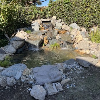 Terrascapes - a small waterfall in a garden - Landscaping Near Me