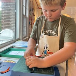 Art Cart Kids - Student uses the Chomp Saw to cut felt for his fiber arts project. Art Cart Kids, Stafford, VA