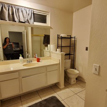 JMF Construction - a woman taking a selfie in a bathroom - General Contractors Near Me