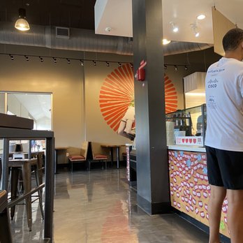 MOD Pizza - a man standing in front of a counter - Fast Food Near Me - Cary, North Carolina