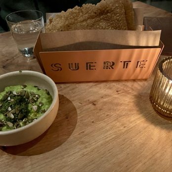 Suerte - Started with the Guacamole with manchego pesto, toasted pepitas, and herbs and sturdy, housemade chips. - Mexican Near Me - Austin, Texas