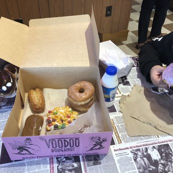 Voodoo Doughnut - Glazed donut, captain crunch, maple bar, buttermilk bar, homer donut, apple fritter (inside the white bag), Portland donut and milk - Donuts Near Me - Houston, Texas Voodoo Doughnut - Glazed donut, captain crunch, maple bar, buttermilk bar, homer donut, apple fritter (inside the white bag), Portland donut and milk - Donuts Near Me - Houston, Texas