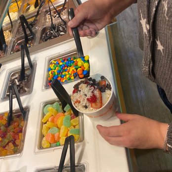 Orange Leaf Frozen Yogurt - a person grabbing a scoop of ice cream - Ice Cream & Frozen Yogurt Near Me - San Antonio, Texas Orange Leaf Frozen Yogurt - a person grabbing a scoop of ice cream - Ice Cream & Frozen Yogurt Near Me - San Antonio, Texas