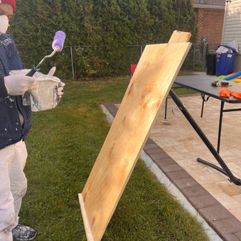 A P S - Painting the wooden slab with the weather resistant paint to stop it from rotting. - Painters Near Me