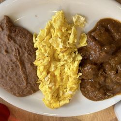 El Toro Mexican Food - Lupito special: carne guisada, eggs, and refried beans