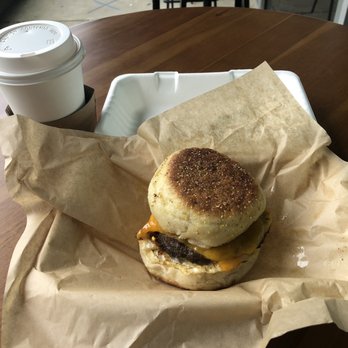 The Optimist - The Basic: Michael's English muffin (or choose croissant instead), fried egg, cheese, added sausage...hot skim latte with it. - Coffee & Tea Near Me - Raleigh, North Carolina The Optimist - The Basic: Michael's English muffin (or choose croissant instead), fried egg, cheese, added sausage...hot skim latte with it. - Coffee & Tea Near Me - Raleigh, North Carolina