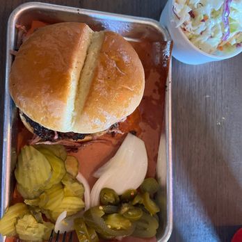 Pody's BBQ - Sliced brisket sandwich and a side of coleslaw. - Barbeque Near Me - Pecos, Texas