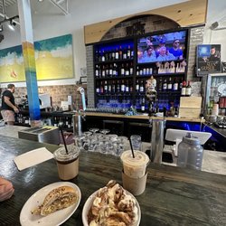 Vichino's Cafe & Wine Bar - Pistachio latte and cinnamon roll, iced coffee and breakfast sandwich