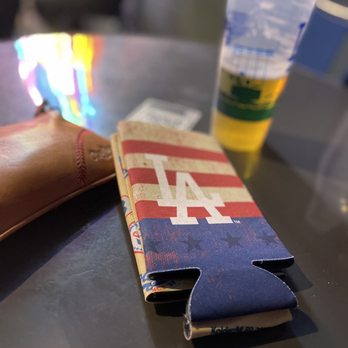 Gold Glove Bar - a beer and wallet on a table - Sports Bars Near Me - Los Angeles, California Gold Glove Bar - a beer and wallet on a table - Sports Bars Near Me - Los Angeles, California