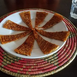 Whatever the first appetizer on the menu is. Tasted like a thick, flat garlic bread with some unknown delicious spice on top.