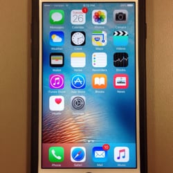 Apple Store - White iPhone 6S with black OtterBox protection case.