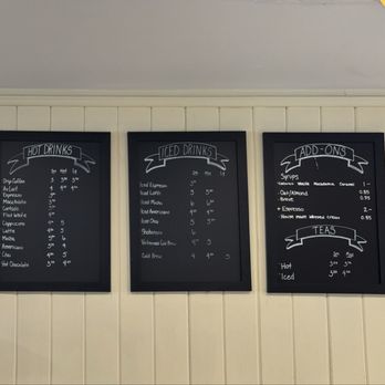 Georgio's Coffee Roaster - Drink Menu - Three black chalkboard menus list hot drinks, iced drinks, and add-ons at Georgio's Coffee Roaster in Stony Brook, NY. - Coffee Roasteries Near Me - Stony Brook, New York