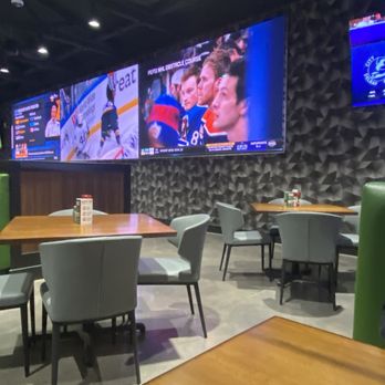 The Greene Turtle Sports Bar & Grille - a man sitting at a table in a sports restaurant - Sports Bars Near Me - Baltimore, Maryland