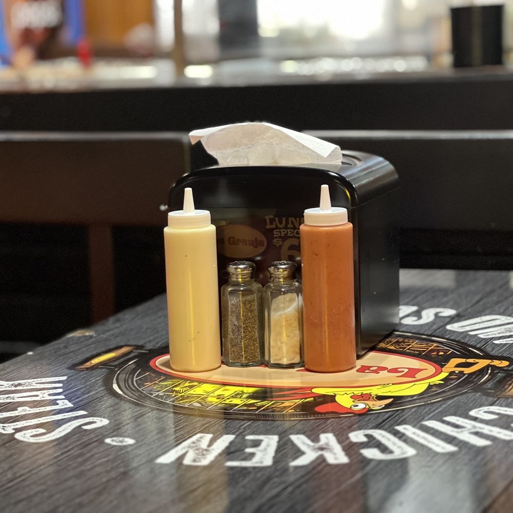 La Granja Restaurant - a table with condiments on it - Latin American Near Me - Margate, Florida La Granja Restaurant - a table with condiments on it - Latin American Near Me - Margate, Florida